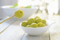 Typical Spanish tapas. Some stuffed olives served on a plate on a white wooden table. Royalty Free Stock Photo