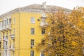 Typical stalin ampir style house in the fall, surrounded by trees with orange leaves Royalty Free Stock Photo