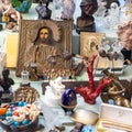 Typical stall on Els Encants flea market at Placa de les Gloriesa. The icon with the saint, sculptures, ceramic figurines, beads