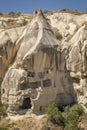 Typical stone dwelling carved in the fairy chimneys with dovecotes carved in the volcanic rock, rock hoodoo in Goreme, Cappadocia