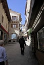 Typical stone street of San Marino with passengers on sunny day, Narrow street in the old town