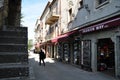 Typical stone street of San Marino. Shops and passers-by on the street