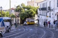 Typical street in the city center of Lisbon with Tram and vintage car in Lisbon, Portugal Royalty Free Stock Photo
