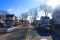 Typical Street in New Jersey with parked cars next to the sidewalk on a sunny day