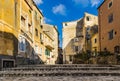 Typical street of old town Corfu city Kerkyra, Greece. Sunny summer day, yellow houses, no people because of Siesta time