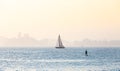 Typical summer afternoon scene in the city of Santos, with sailboats and stand up paddle practitioner