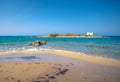 Typical summer image of an amazing pictorial view of a sandy beach and an old white church in a small isl