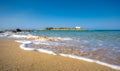 Typical summer image of an amazing pictorial view of a sandy beach and an old white church in a small isl