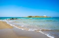 Typical summer image of an amazing pictorial view of a sandy beach and an old white church in a small isl