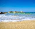 Typical summer image of an amazing pictorial view of a sandy beach and an old white church in a small isl