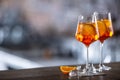 Typical summer sekt drink aperol spritz served in wine glass with aperol, prosecco, soda and a slice of orange