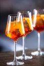 Typical summer sekt drink aperol spritz served in wine glasses with aperol, prosecco, soda and a slice of orange