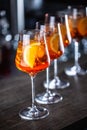 Typical summer sekt drink aperol spritz served in wine glasses with aperol, prosecco, soda and a slice of orange