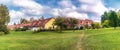 Typical Swedish middle class wooden terraced houses in Umea. Residential yellow townhouses with red orange clay tiles on blue sky Royalty Free Stock Photo