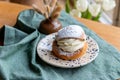 Typical Swedish semla with sweet cream on te blue textile Royalty Free Stock Photo
