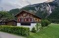 Typical switzerland wooden house and beautiful Oltschibach Waterfall,viewed from Unterbach village, Switzerland