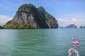 Typical Thailand picture: cliffs in the sea with the Thai flag