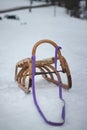 Typical tool for driving downhill. Wooden historic sleigh with purple strap. Winter fun in the mountains. Czech republic Royalty Free Stock Photo