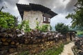 Traditional Bhutanese farmhouse , with firewood on the fence wall , Ura Valley , Bhutan