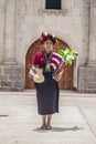 Young lady with typical, traditional and cultural dress of cajola, with flowers in hand background door