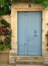 Lightblue wooden door in traditional wall Royalty Free Stock Photo