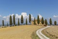 Typical tuscany landscape: a road, cypress trees and a villa