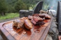Typical Uruguayan and Argentine Asado Cooked on fire. Entrana and Vacio meat cuts. Accompanied with Chorizo Royalty Free Stock Photo