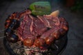 Typical Uruguayan and Argentine Asado Cooked on fire. Entrana and Vacio meat cuts. Accompanied with Chorizo Royalty Free Stock Photo