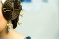 Typical Valencian fallera bun, traditional Spanish hairstyle and decorative earrings, negative space for text Royalty Free Stock Photo