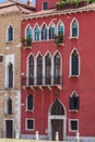 Typical venetian building, red walls with white gothic windows