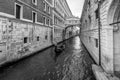 A typical Venetian gondola navigates the canal that passes under the famous Ponte dei Sospiri, Venice, Italy