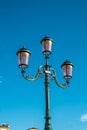 Typical Venetian lamppost with a blue background