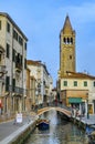 Typical Venice canal with the church of San Barnaba, with local and tourists, in Venice