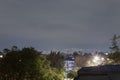 A typical view from rooftop outside suburbs neighborhood night lights at latin american city with cloudy sky Royalty Free Stock Photo