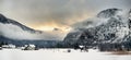 Typical view of small alps village from window of train in snowy winter day Royalty Free Stock Photo