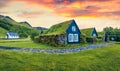 Typical view of turf-top houses in Icelandic countryside. Dramatic summer sunrise in Skogar village, south Iceland, Europe.