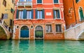 Weathered building facade on a picturesque canal in Venice Italy