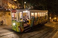 Typical vintage electrical tram funicular running at night in Lisbon, Portugal