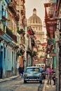 HAVANA, CUBA- JAN 30, 2018: typical vintage view of a street of old havana, cuba with peoples and old cars