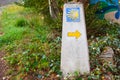 Typical Way of Saint James Camino de Santiago milestone with a yellow shell and yellow arrow Royalty Free Stock Photo