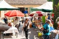Typical weekend flea market with patrons blurred in motion as they lood at offerings Royalty Free Stock Photo