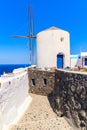 Typical white windmill on street of Oia village, Santorini island, Greece Royalty Free Stock Photo