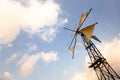 A typical windmill at the Lassithi plateau, Crete island in Greece under a cloudy blue sky