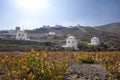 Typical windmill in Santorini. White buildings on a hill, a windmill and trees, is typical for Santorini, Greece. Famous Windmills