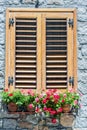 Typical window of a stone house with wooden shutters closed and Royalty Free Stock Photo