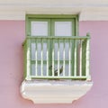 Wooden balcony with green railings in residential pink house in historic center of Havana, Cuba. Royalty Free Stock Photo