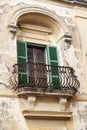 Typical wooden balcony with shutter on old building in Mdina, Ma Royalty Free Stock Photo