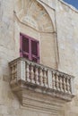 Typical wooden balcony with shutter on old building in Mdina, Ma Royalty Free Stock Photo