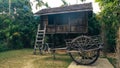 Typical wooden house in a rural setting Thailand. Sunset on teak cart on green grass garden in front of Thai classic style teak Royalty Free Stock Photo