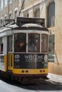 Typical Yellow Vintage Tram in Narrow Street of Lisbon, Portugal Royalty Free Stock Photo